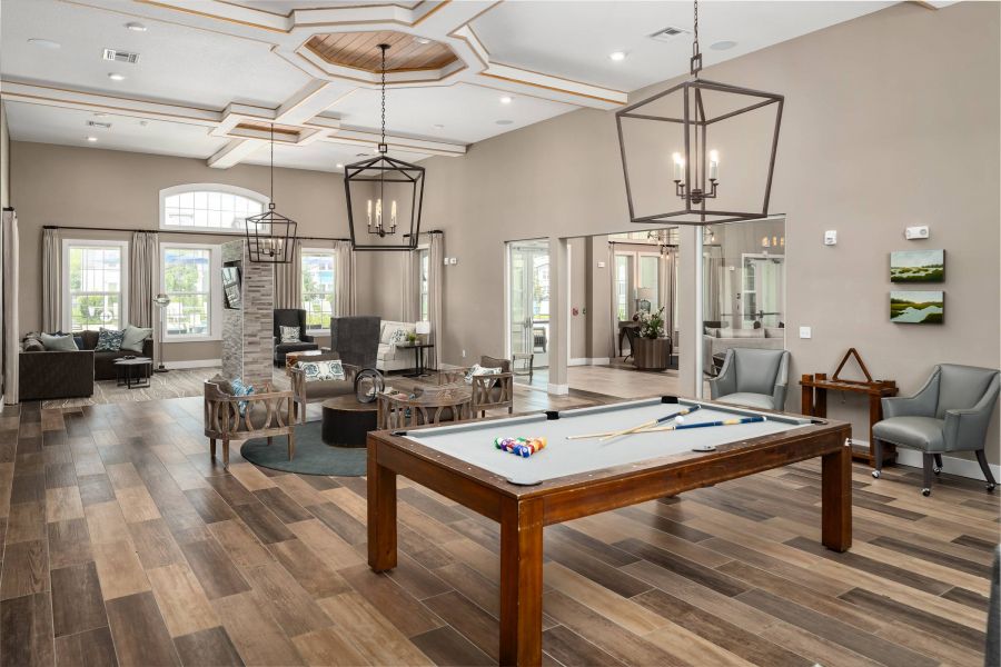 Shadetree Apartments with Spacious lounge with a pool table, modern seating, large windows, and stylish light fixtures.