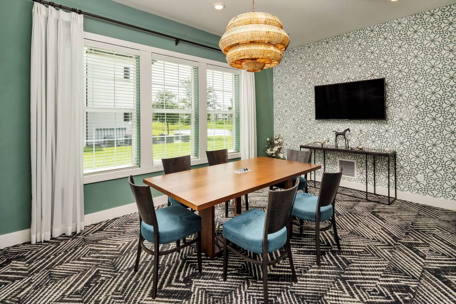 Shadetree Apartments with Modern dining room with a wooden table, six chairs, patterned carpet, and large windows with white curtains.