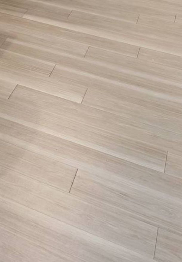 Shadetree Apartments with Light-colored wooden floor tiles with an uneven, misaligned installation pattern.