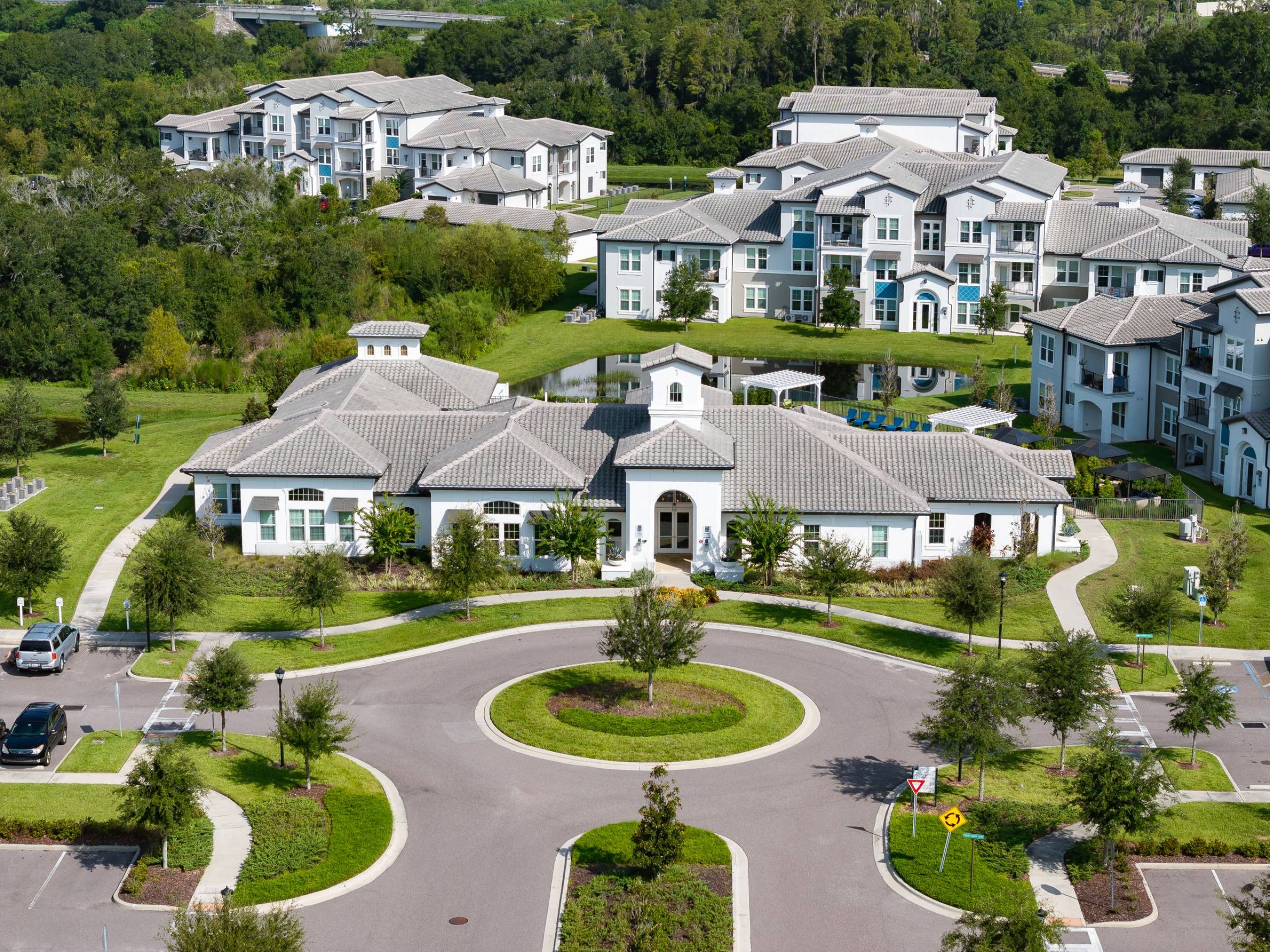 Shadetree Apartments with Aerial view of a modern apartment complex with landscaped grounds and a circular driveway.