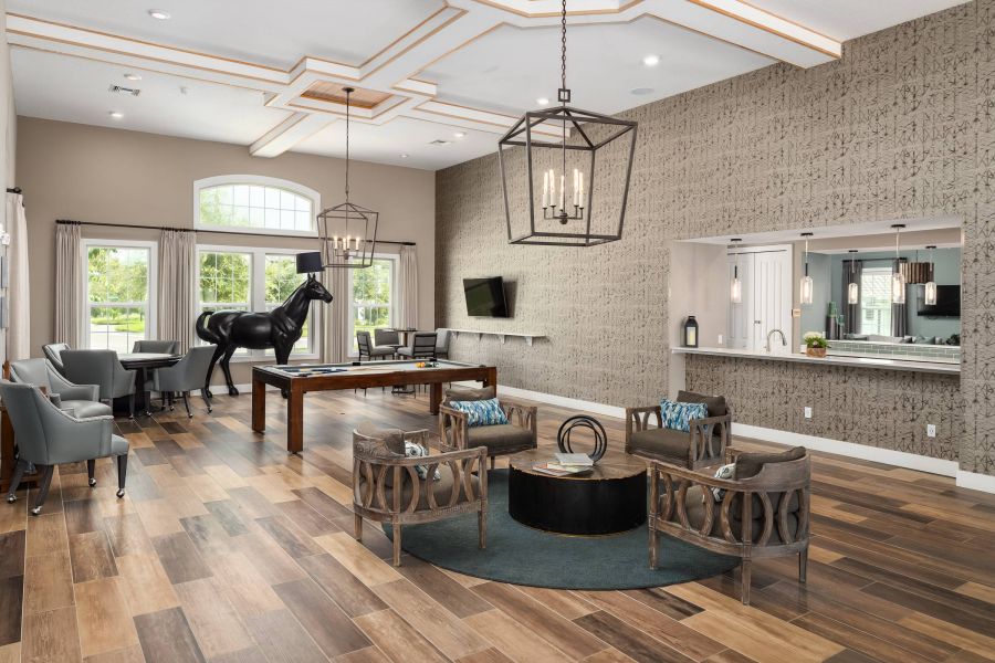Shadetree Apartments with Modern lounge with wood floors, a pool table, lounge chairs, and a black horse statue by large windows.